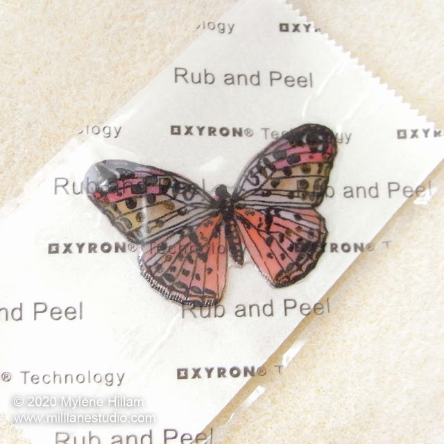 Resined butterfly on Xyron Sticker Maker backing paper