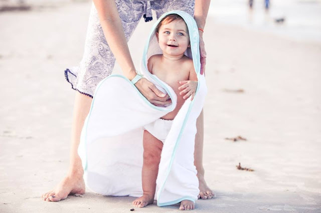 Baby wrapped in hooded towel