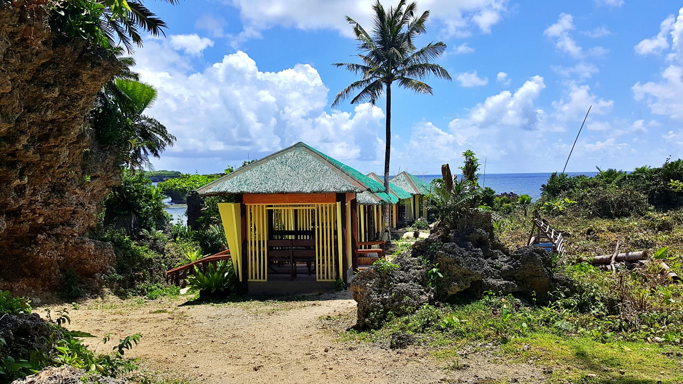 view of the cottages and craggy cliffs from the entrance of Canhugas Nature Park in Hernani Eastern Samar