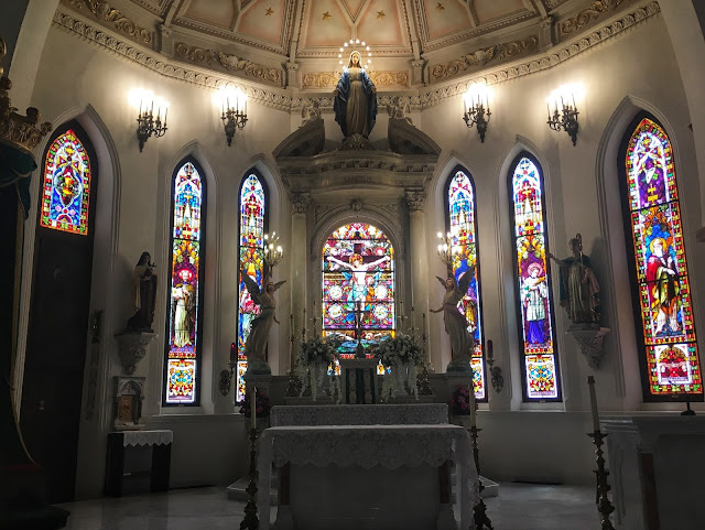 the altar and beautiful stained glass inside St. Patrick Cathedral in downtown Fort Worth, Texas