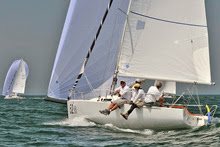 J/80 one-design sailboat- planing along under spinnaker