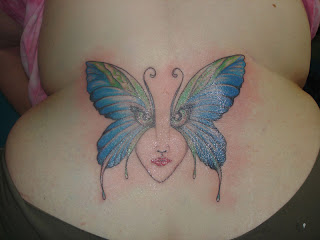 butterfly with angle eyes on lower back