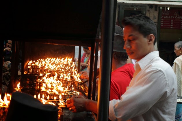 Lighting of Butter Lamps at a temple in Kathmandu