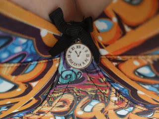 Close up on the clock shaped charm on the Graffiti's gore