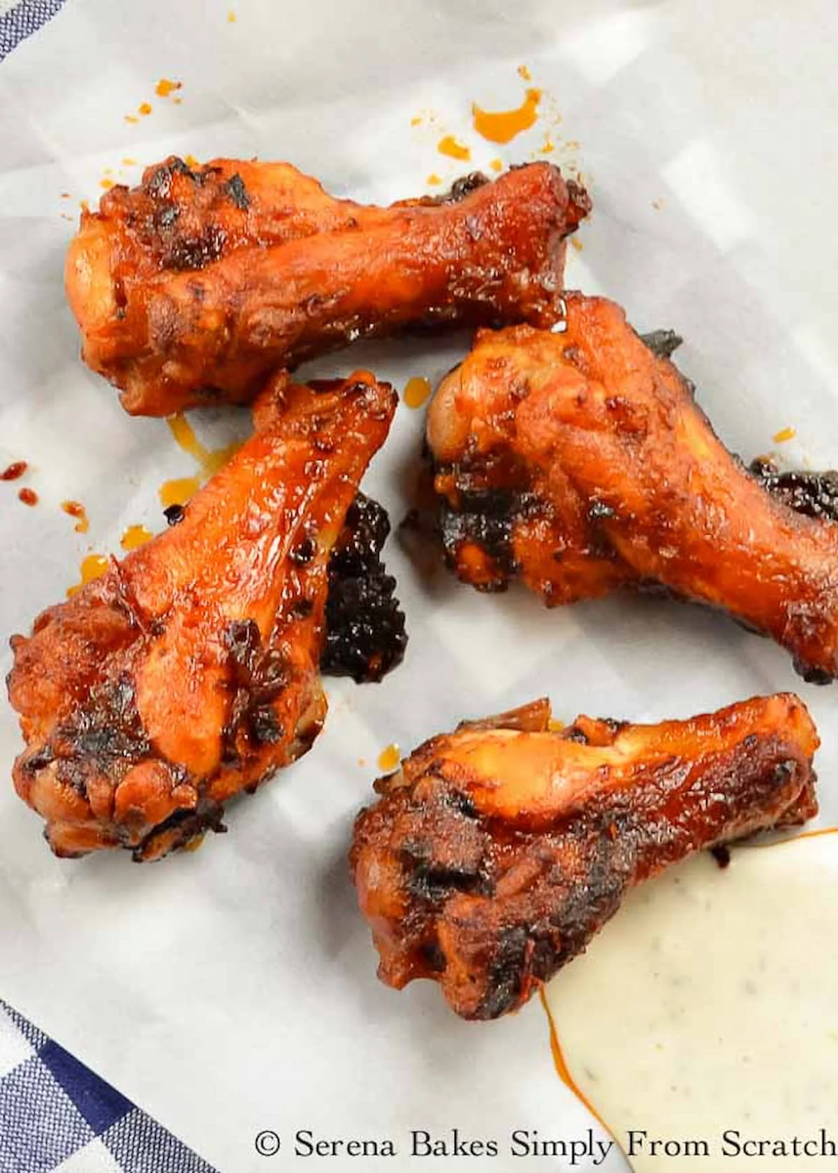 A down shot of Honey Chipotle Chicken Wings on a large piece of parchment paper.
