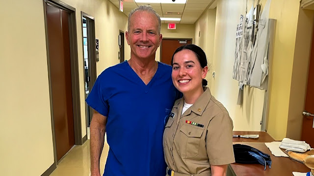 Retired Navy Capt. William Roberts, a family medicine physician at Naval Hospital Camp Pendleton, poses with Ens. Hannah Ortiz, a USU medical student on a family medicine rotation at NHCP. More than two decades ago, Roberts delivered Ortiz at the Camp Pendleton Naval Hospital and the two recently reconnected during the five-week rotation. (Photo courtesy of Dr. William Roberts)