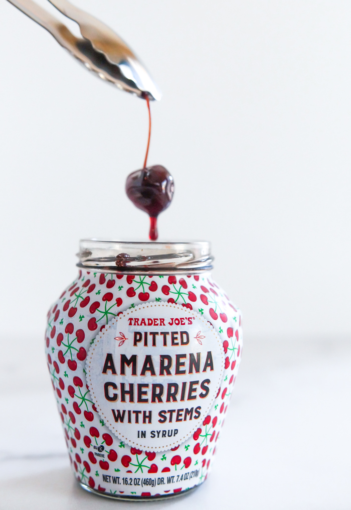 trader joe's amarena cherries, lifting one out of jar