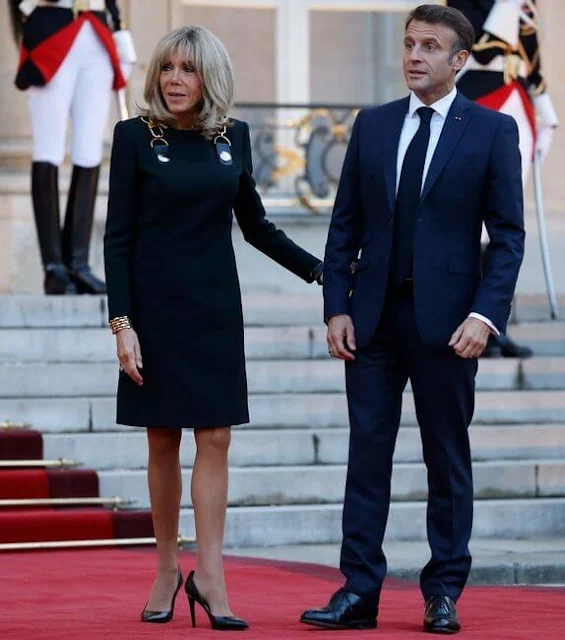 French President Emmanuel Macron and his wife Brigitte Macron. Queen Camilla wore a shirt dress by Samantha Sung