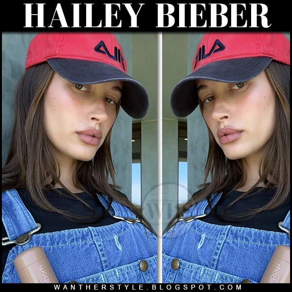 Hailey Bieber in denim overalls and red hat