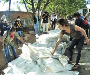 Honduran prison fire: searching through body bags