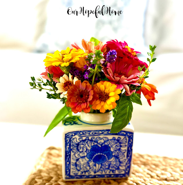 blue and white chinoiserie vase filled with zinnias