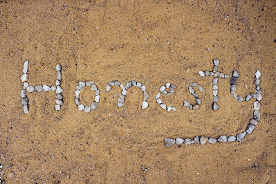 the word 'honesty', written with stones