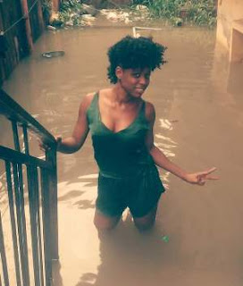 Photos: Young Nigerian Lady Strikes A Pose Before Her Flooded Home In Yaba