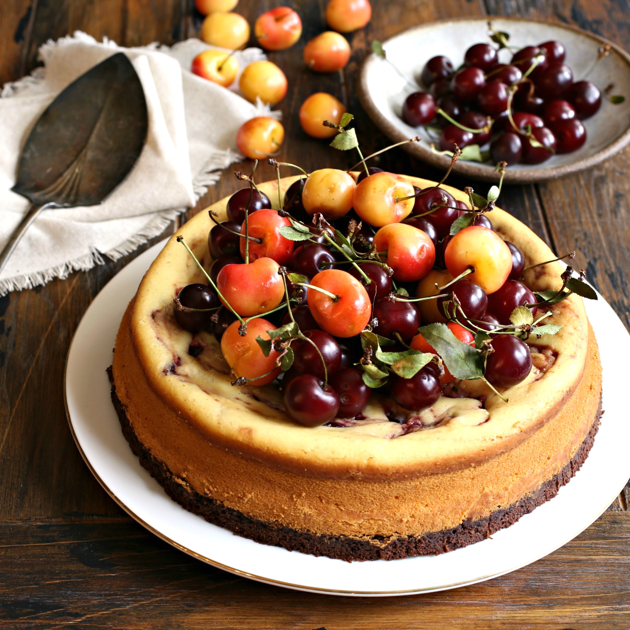 Recipe for cheesecake with a brownie base and cherry preserves swirl.