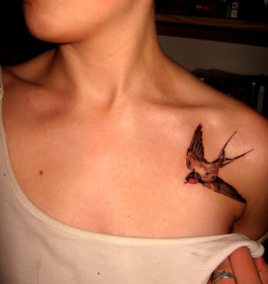 Swallows tattoo at man's back.