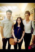 Kevin and Dani Jonas pose for a photo with a fan yesterday at the mall