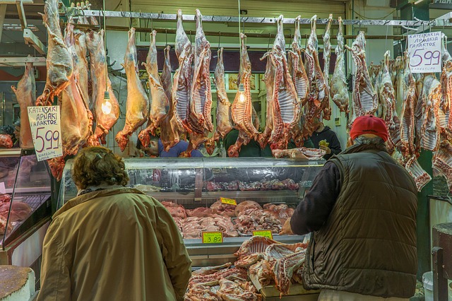 Couple buying meat from a display case