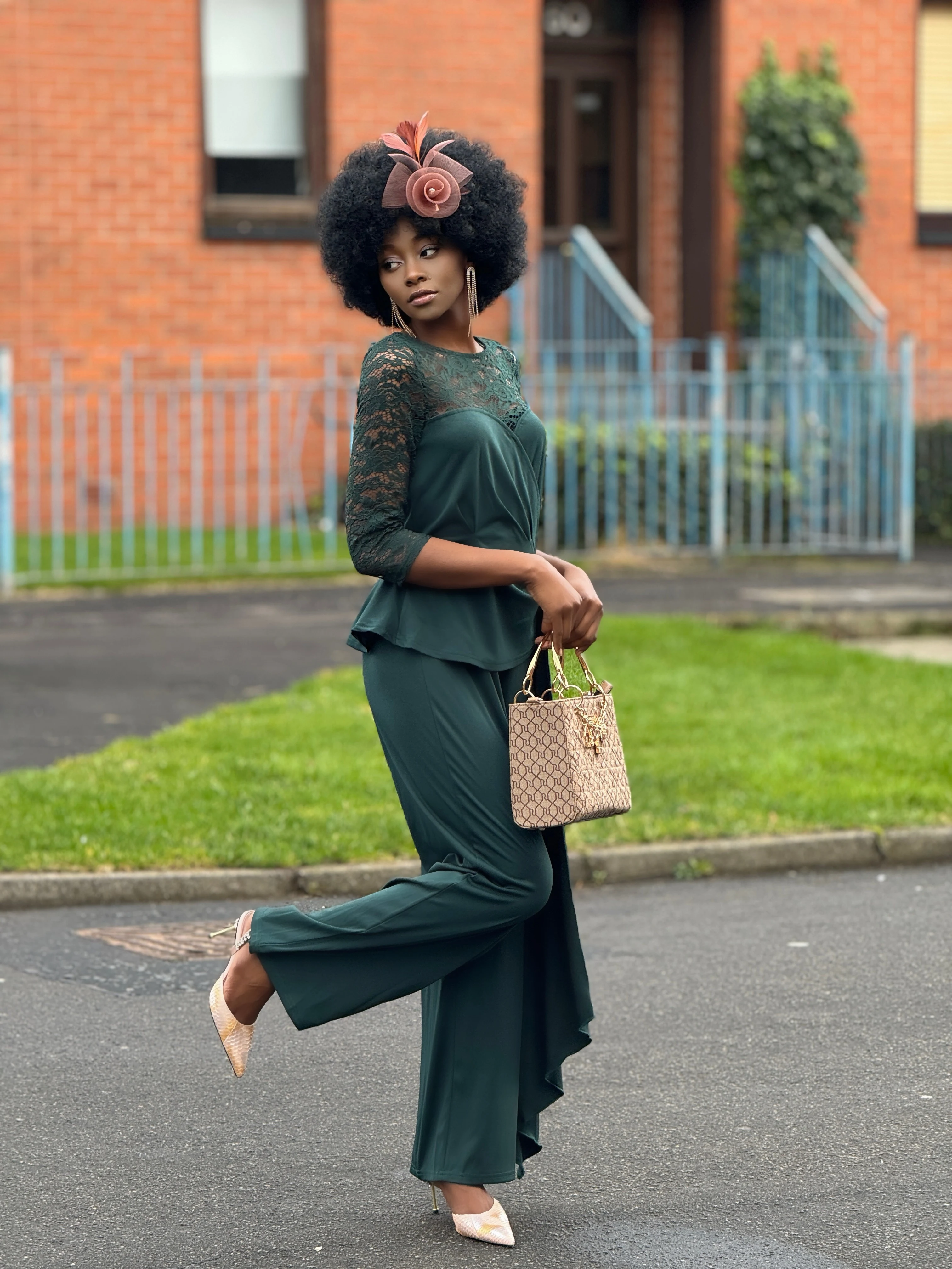 Lace stitching adds a touch of elegance to this green jumpsuit, ideal for special events.