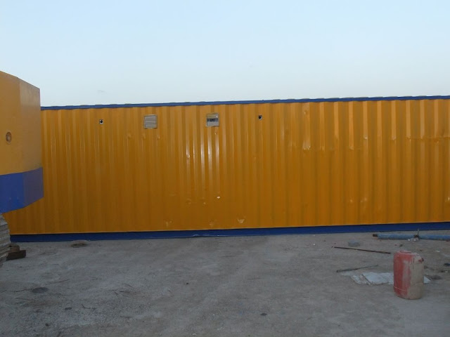 Picture of yellow trailer with construction equipment on the Kingdom Tower construction site
