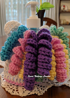 Sweet Nothings Crochet free crochet pattern blog, free crochet pattern for a unicorn soap dispenser bottle cover, this blog has video tutorials, photo with detail of unicorn hair tendrils,