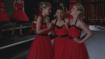 Brittany, Santana, and Quinn huddled together laughing