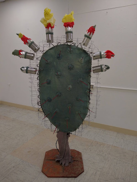 Sculpture of a cactus made of found objects by Jackie Jax Williams