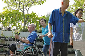 Nursing home resident Tan Soo Siam (far left), 72, says it is much nicer in the therapeutic garden than indoors.