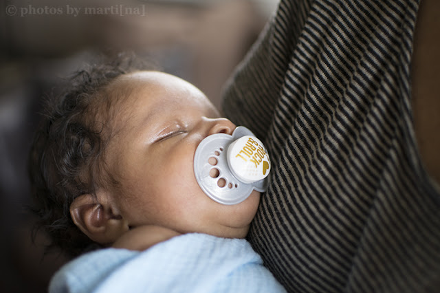 Mother holding her newborn baby boy, photo by Martina