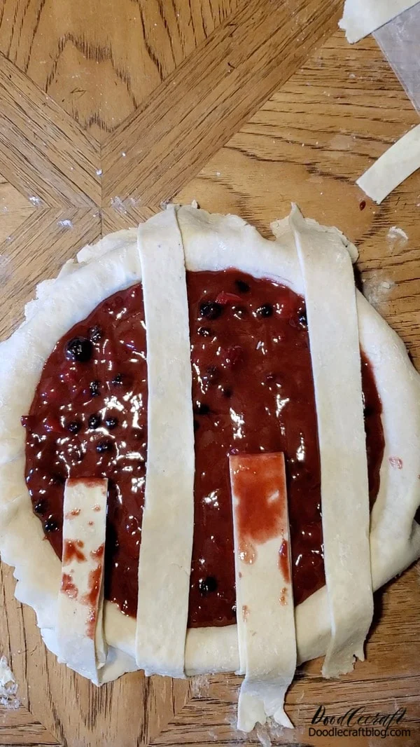 Cut the extra pie crust into strips for making a simple lattice on the top of the pie...or cut out a little hand to put on top for the added carnival pie experience.