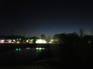 A crescent Moon and a planet, probably Venus, seen from Lowes Grove after sunset in April 2018; a former Citgo gas station is on the left and a BP is on the right. ©