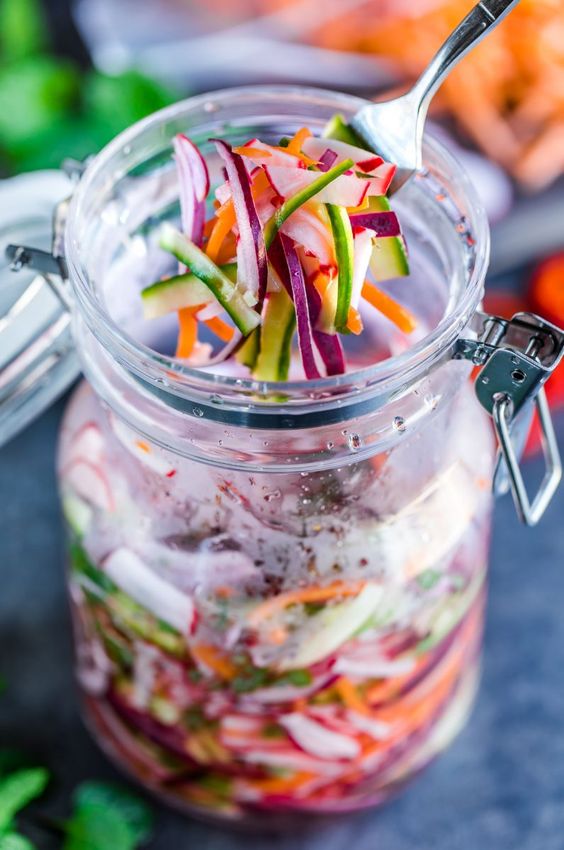 Quick Fridge Pickled Vegetables make the ultimate topping for tacos, burgers, and more! Featuring a blend of carrots, cucumber, radish, and onion, this healthy recipe is fast and flavorful!