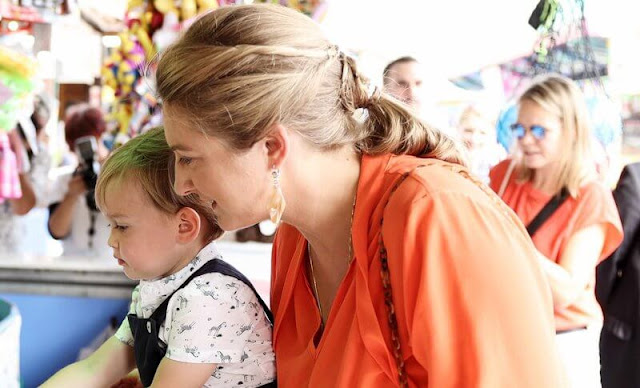 Princess Stephanie wore an orange silk blouse by Boden, Hobbs. Prince Charles wore Tartine et Chocolat linen dungarees