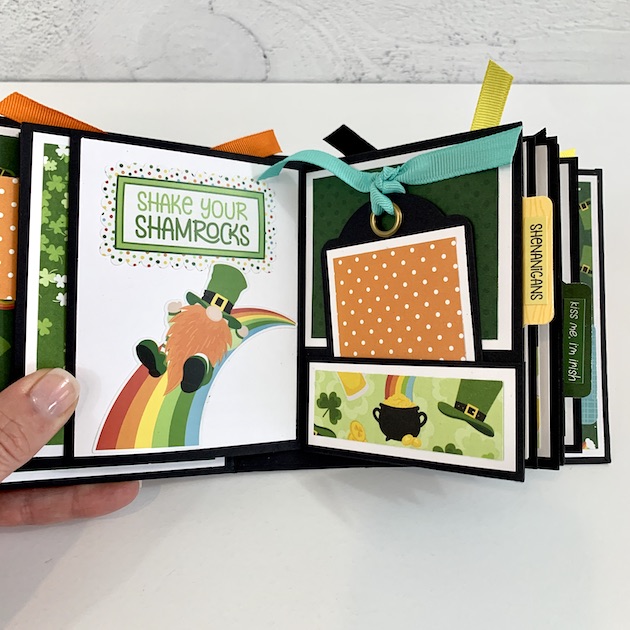 Lucky Charm mini scrapbook album with leprechaun gnomes, pots of gold, and rainbows