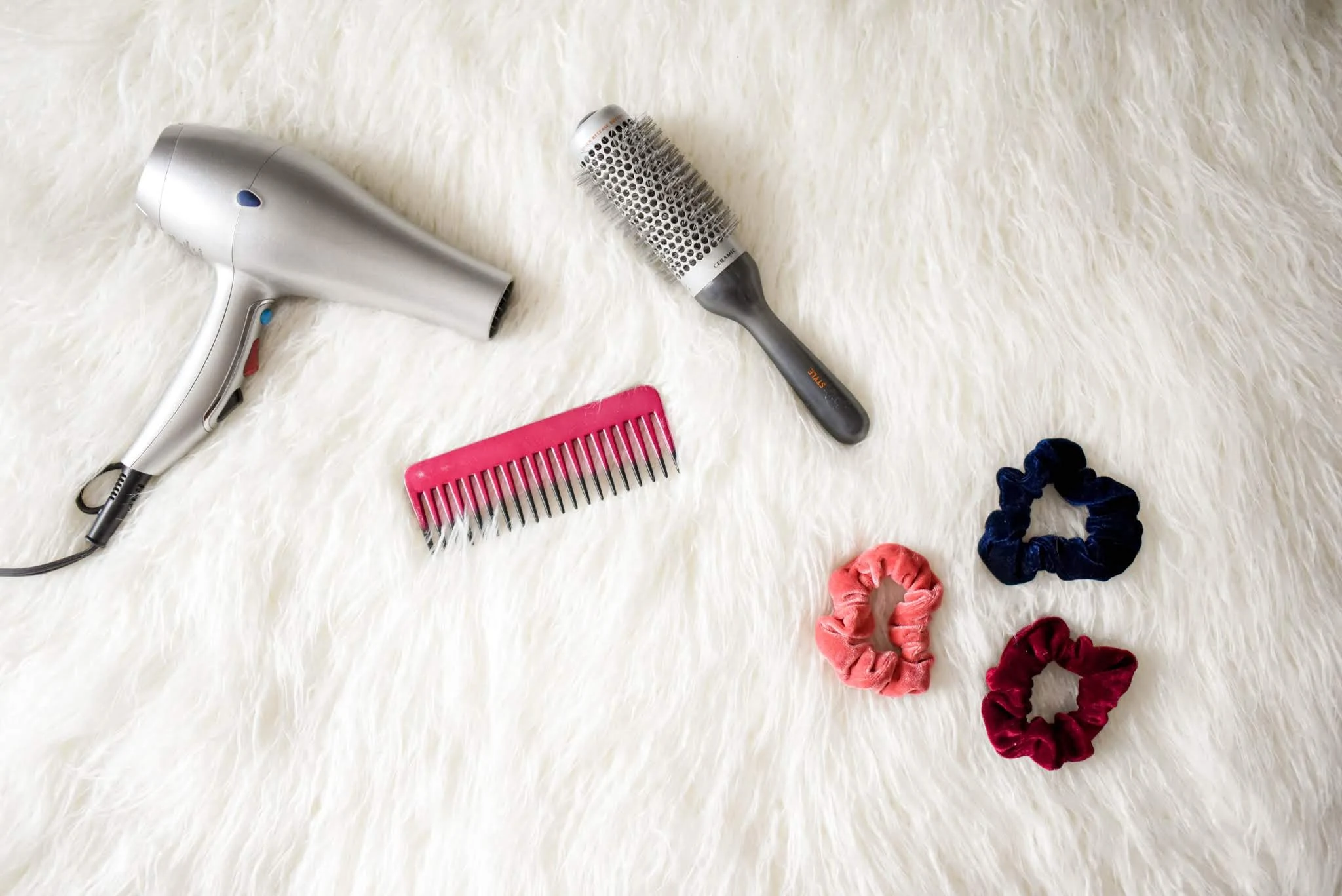 hair products and tolls on a faux fur rug