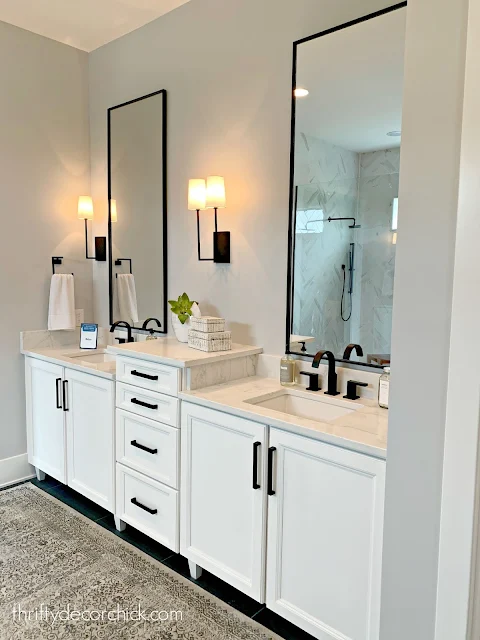 Modern master bath with white cabinets and black accents 