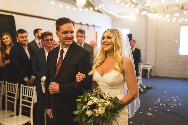 bride walking down aisle with father