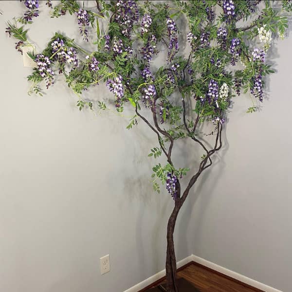 paper sculpture wisteria tree standing in corner of room