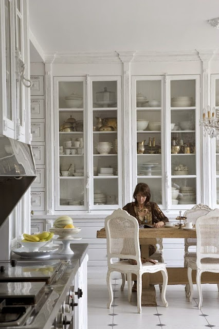 white kitchen tall floor to ceiling glass door cabinets