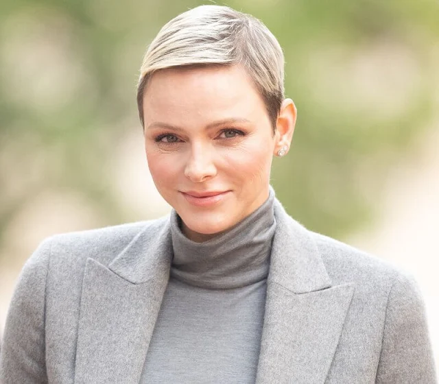 Prince Albert, Princess Charlene, Prince Jacques and Princess Gabriella. Charlene wore a grey jacket, sweater and skirt by Akris