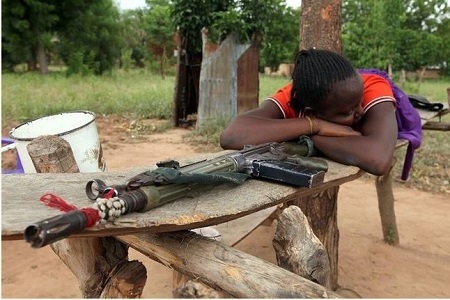 See Photo of an Agatu Woman Lying Beside Her Husband's Gun Because of Fulani Herdsmen Attacks