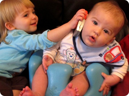 Elaine helping Nolan talk on the phone