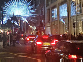 Pic of back of cars and red lights blocking yellow box junction and pedestrians