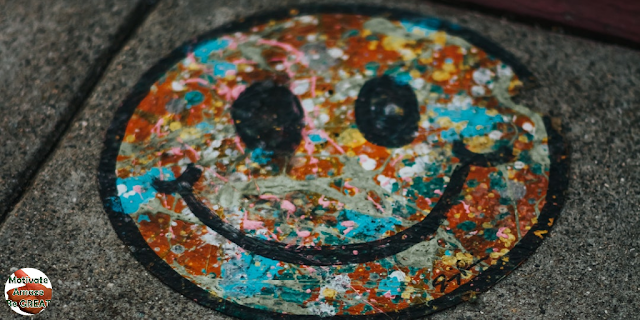 Featured in the article: "Art Therapy Benefits For Mental Health Improvement ". Represents a artwork of a colored smiling face, how art can boost your self esteem.