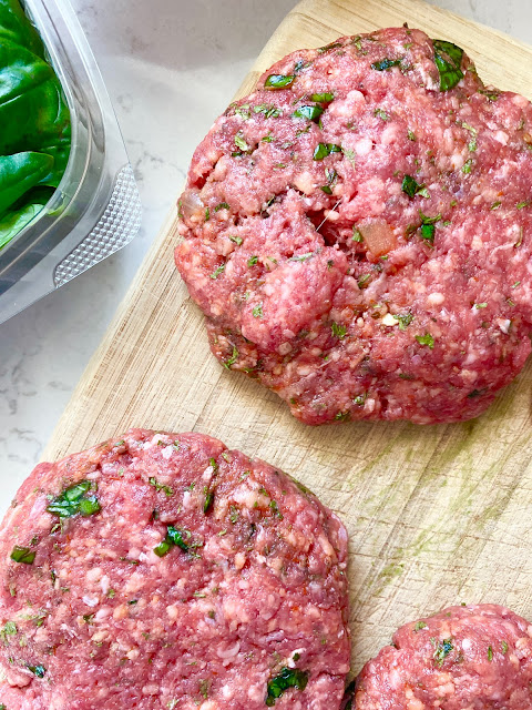 Photo of burger patties form and on a cutting board.