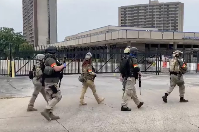 A militia group marches up 7th St. in downtown Louisville. They wouldn’t identify their group, but I know I’ve seen some here before