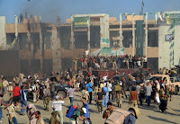 Rebels and their supporters celebrate outside Libyan leader Moammar Gadhfai's heavily damaged Bab al-Azizya compound in the centre of Tripoli on Wednesday.