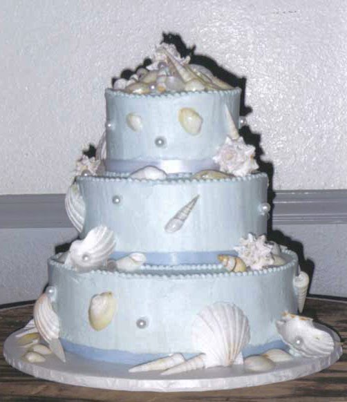 Metallic light blue beach wedding cake with white seashells and light blue