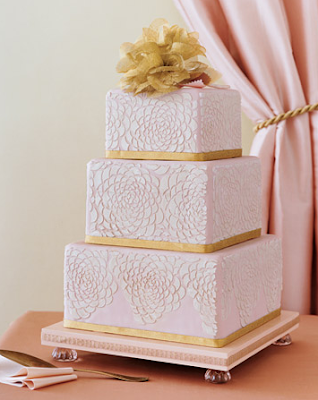 Bands of gold anchor the beautiful tiered blush pink cake with embossed 