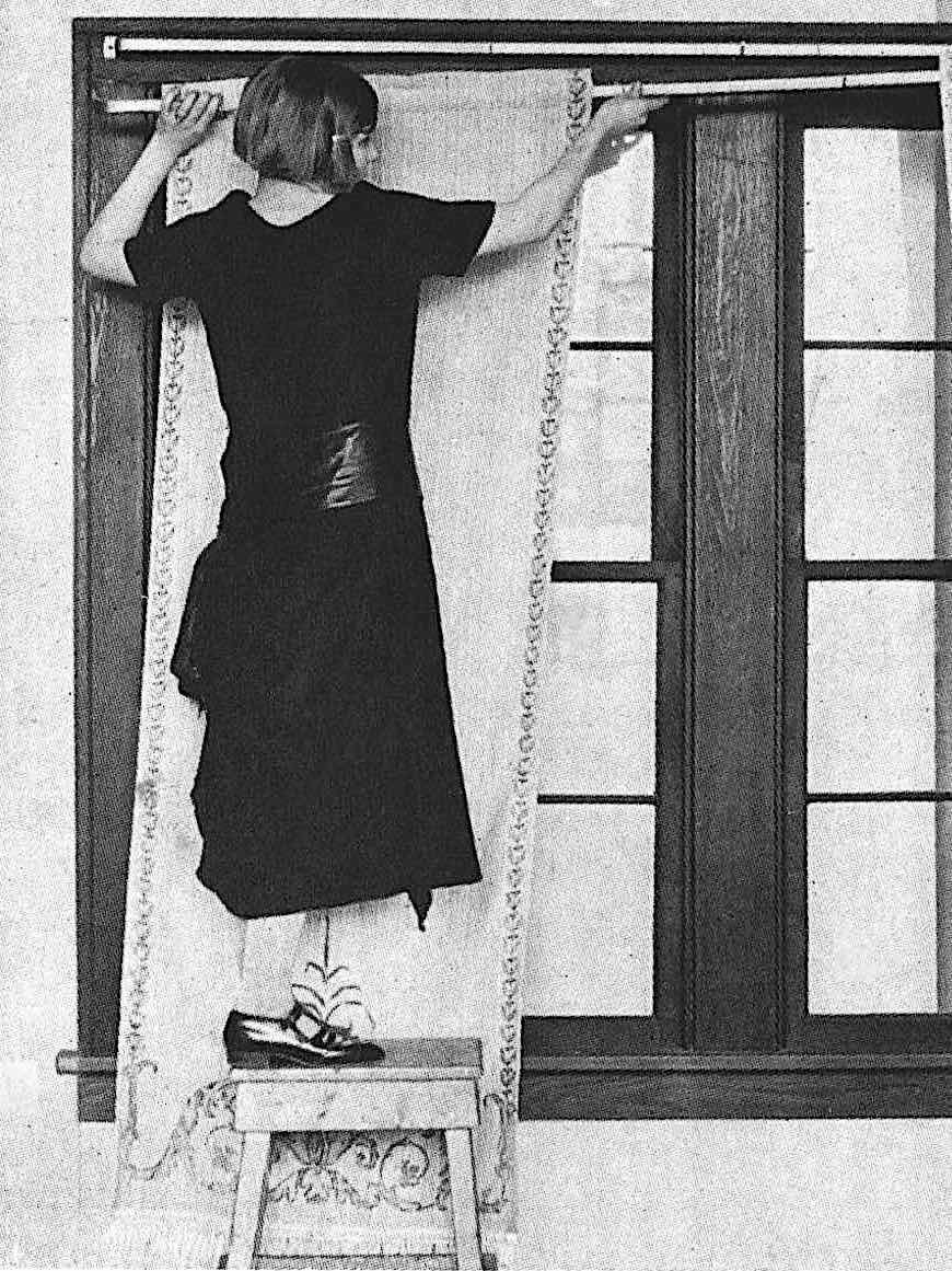 a 1925 catalog model demonstrating curtain hanging