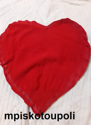 A HEART PILLOW WITH POM POM